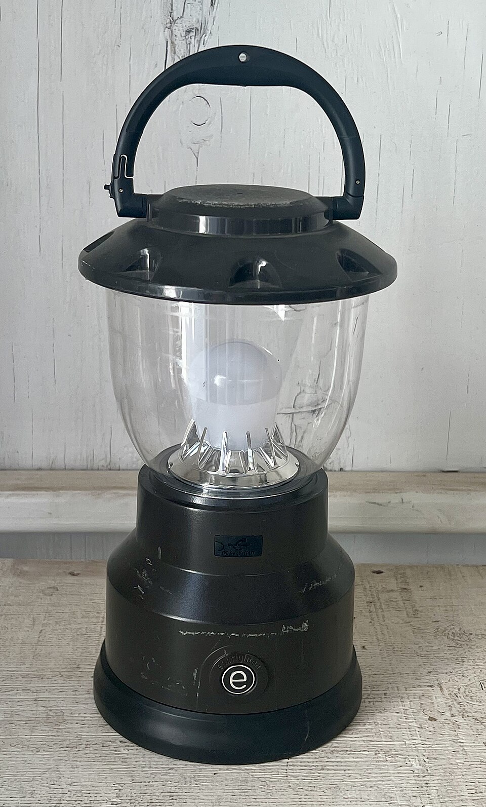 A black LED camping lantern with a clear globe and a top carry handle, for storm prep in Pensacola, FL